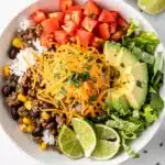 Easy taco rice bowl with seasoned beef beans corn cheese and fresh toppings