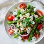Asparagus feta salad with cherry tomatoes pine nuts and lemon dressing