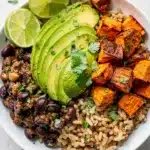 Healthy black bean sweet potato bowls with avocado and cilantro on rice