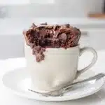 Moist one bowl chocolate mug cake with ice cream and chocolate sauce.