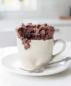 Moist one bowl chocolate mug cake with ice cream and chocolate sauce.