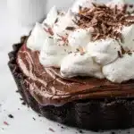 Slice of homemade chocolate pudding pie with creamy filling on a fork