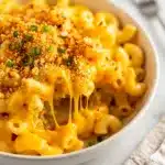 Creamy stovetop mac and cheese recipe in a white ceramic bowl.
