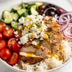 Greek chicken salad bowls with feta olives and crisp cucumbers close up