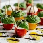 Colorful mini caprese skewers with tomatoes mozzarella and basil glaze