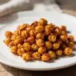Crispy roasted chickpeas recipe in a rustic ceramic bowl on wood.
