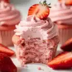 Moist strawberry cupcakes with creamy pink buttercream frosting close up