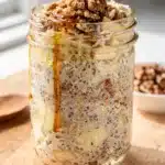 Apple cinnamon overnight oats in a jar with walnuts and cinnamon stick