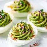 Avocado deviled eggs recipe with creamy filling and fresh chives garnish
