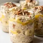 Creamy banana bread overnight oats in a jar with walnuts and cinnamon.