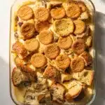 Creamy banana pudding bread pudding with vanilla wafer topping in ceramic dish