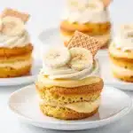 Moist banana cupcake topped with creamy vanilla whipped cream and fresh banana slice.