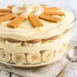 Layered Southern banana pudding in clear glass trifle bowl with vanilla wafers