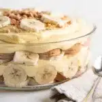Classic banana pudding in a glass bowl with creamy layers and vanilla wafers.