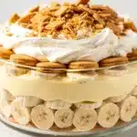 Creamy banana pudding trifle with whipped cream in a glass bowl