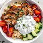 Chicken Shawarma Bowls feature juicy spiced chicken with tzatziki and fresh vegetables.