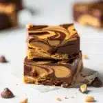 Creamy chocolate peanut butter fudge swirls in a homemade dessert recipe.