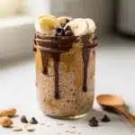 Creamy chocolate peanut butter overnight oats in a clear glass jar