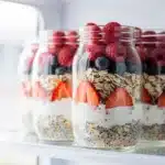 Creamy overnight oats with fresh berries in a glass mason jar