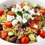 Cold Mediterranean orzo salad with feta olives and fresh herbs plated