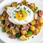 Crispy corned beef hash with garlic butter potatoes and fried egg