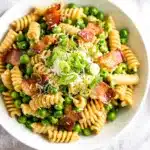 Creamy bacon pea pasta salad with rotini and a glossy dressing