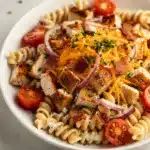 Creamy chicken bacon ranch pasta salad with rotini tomatoes cheese and chives