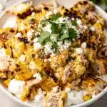 Creamy chicken street corn dip with charred corn and cotija cheese