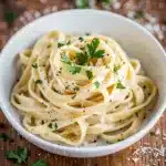 Creamy garlic parmesan pasta with fettuccine in a glossy cheese sauce.