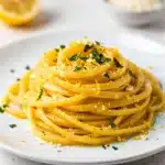 Creamy lemon garlic pasta with fresh parsley and black pepper garnish.