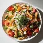 Creamy ranch pasta salad recipe with rotini cucumbers tomatoes and carrots