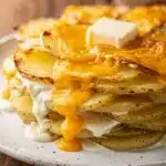 Creamy crockpot scalloped potatoes recipe with golden brown bubbly cheese topping.