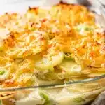 Creamy scalloped potatoes with leeks and a golden cheese crust in a dish.
