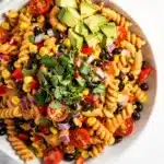 Creamy Southwest Pasta Salad with avocado and black beans in a bowl.