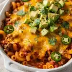 Creamy taco pasta bake with ground beef and bubbly cheese in ceramic dish