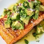 Perfectly seared crispy skin salmon with vibrant chunky avocado salsa topping.