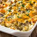 Creamy crockpot hashbrown casserole with mushrooms and melted cheddar cheese.