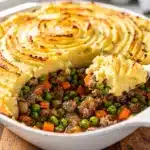 Easy Shepherds Pie with Cheddar Mash in a rustic ceramic baking dish
