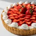 Fresh strawberry cream pie with a graham cracker crust and glossy berry glaze.