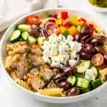 Greek chicken pasta salad with juicy chicken, pasta, and feta cheese.