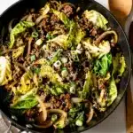 Savory ground beef stir fry with cabbage in glossy sauce, served with rice.