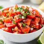 Colorful homemade pico de gallo recipe with fresh tomatoes onion and cilantro