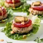 Juicy turkey burger in lettuce with tomato onion pickle and creamy sauce