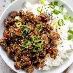 Korean ground beef bowls with rice, scallions, and toasted sesame seeds.