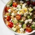 Vibrant lemon orzo pasta salad with fresh dill, cucumber, tomatoes, and feta.