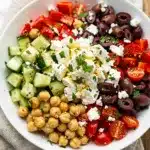 Crisp Mediterranean chickpea salad bowl with fresh vegetables and zesty lemon dressing.
