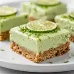 No bake key lime pie bars with creamy filling and fresh lime zest topping.