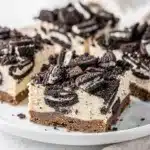 No bake Oreo cheesecake bars with creamy filling and cookie crust.
