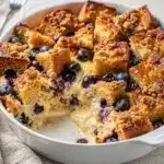 Overnight French toast bake with blueberry streusel and maple syrup.