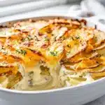 Scalloped potatoes with roasted garlic in a creamy golden cheese crust.